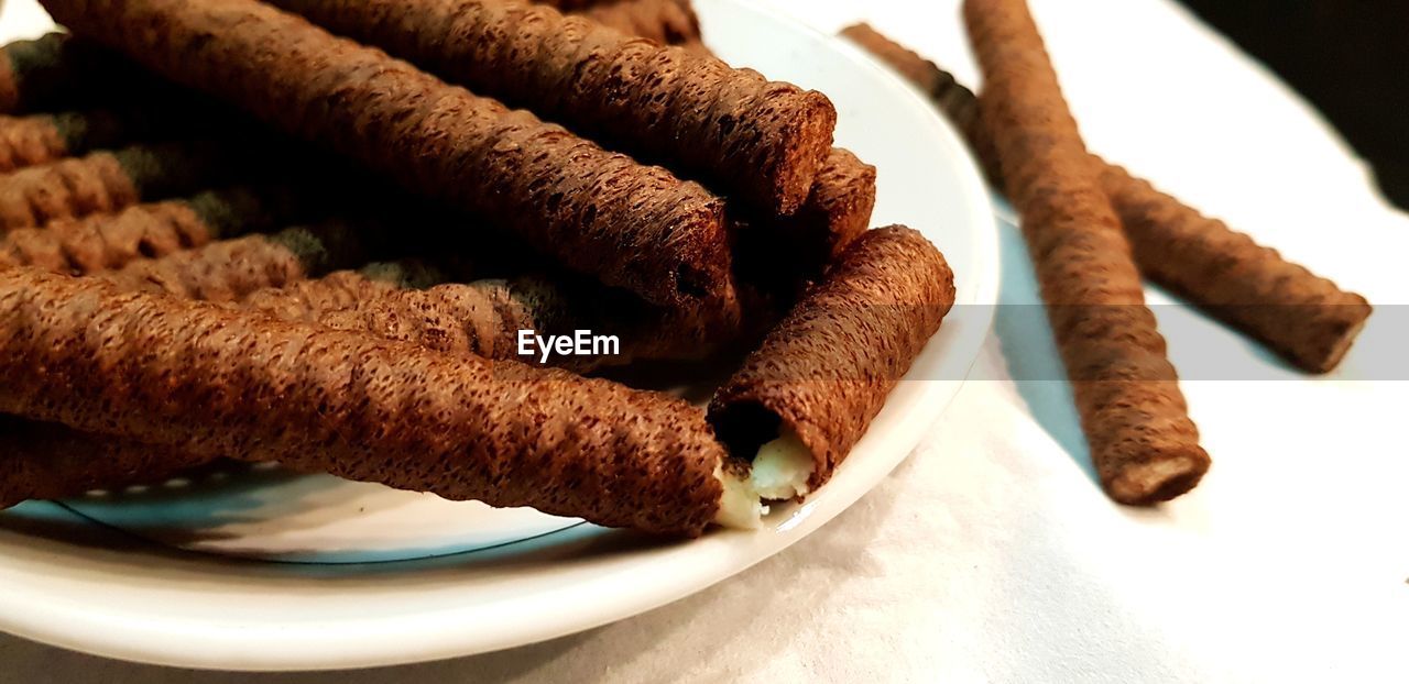 Close-up of chocolate sticks in plate on table