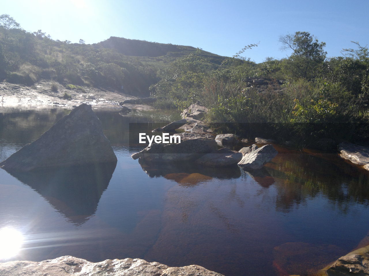 SCENIC SHOT OF REFLECTION OF MOUNTAIN RANGE IN CALM LAKE