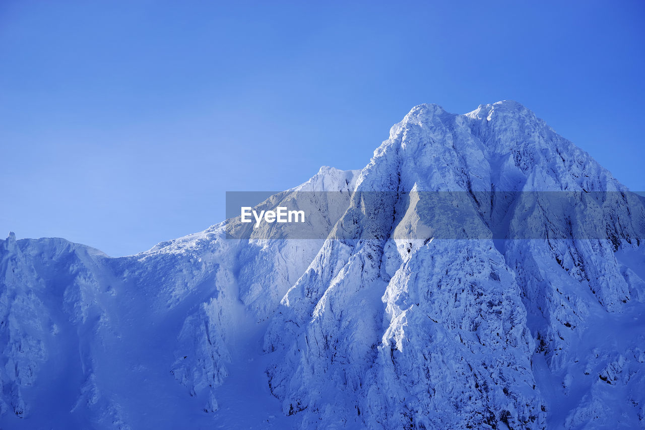 SNOWCAPPED MOUNTAIN AGAINST BLUE SKY