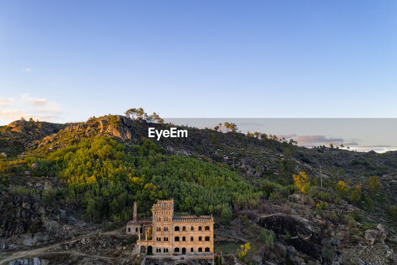 Drone aerial panorama of termas radium hotel serra da pena at sunset in sortelha, portugal