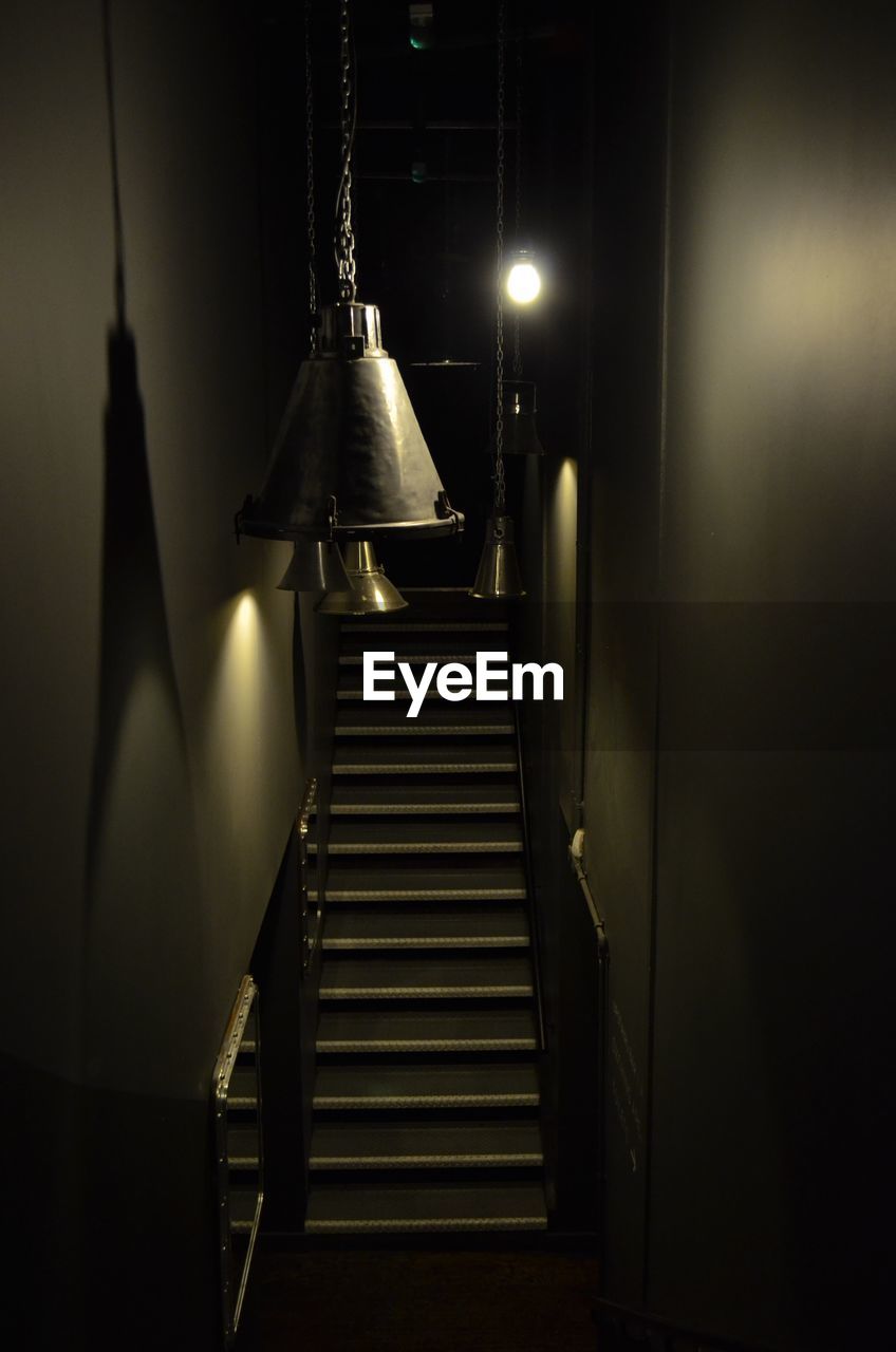 LOW ANGLE VIEW OF ILLUMINATED STEPS IN BUILDING