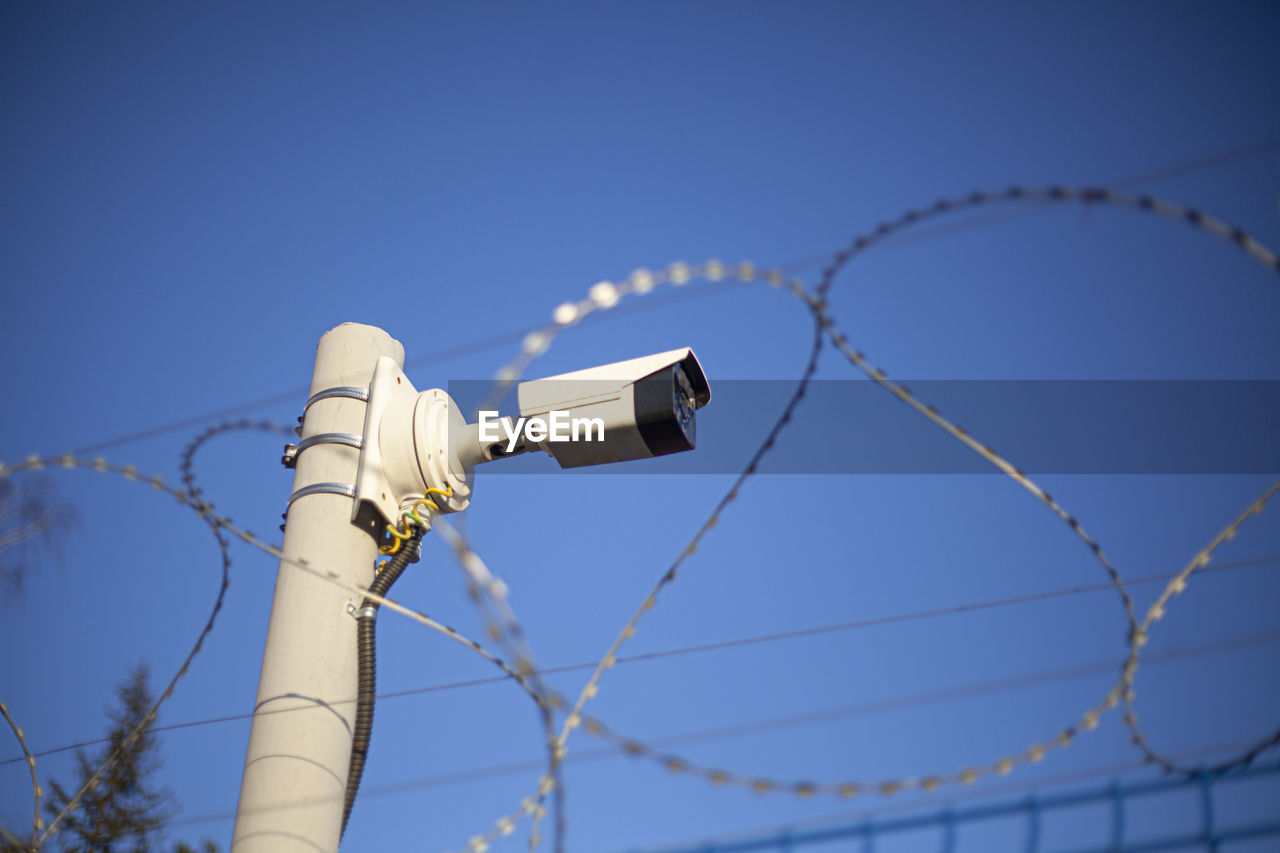 Camcorder on the fence. protected area. perimeter security. barbed wire and surveillance. 