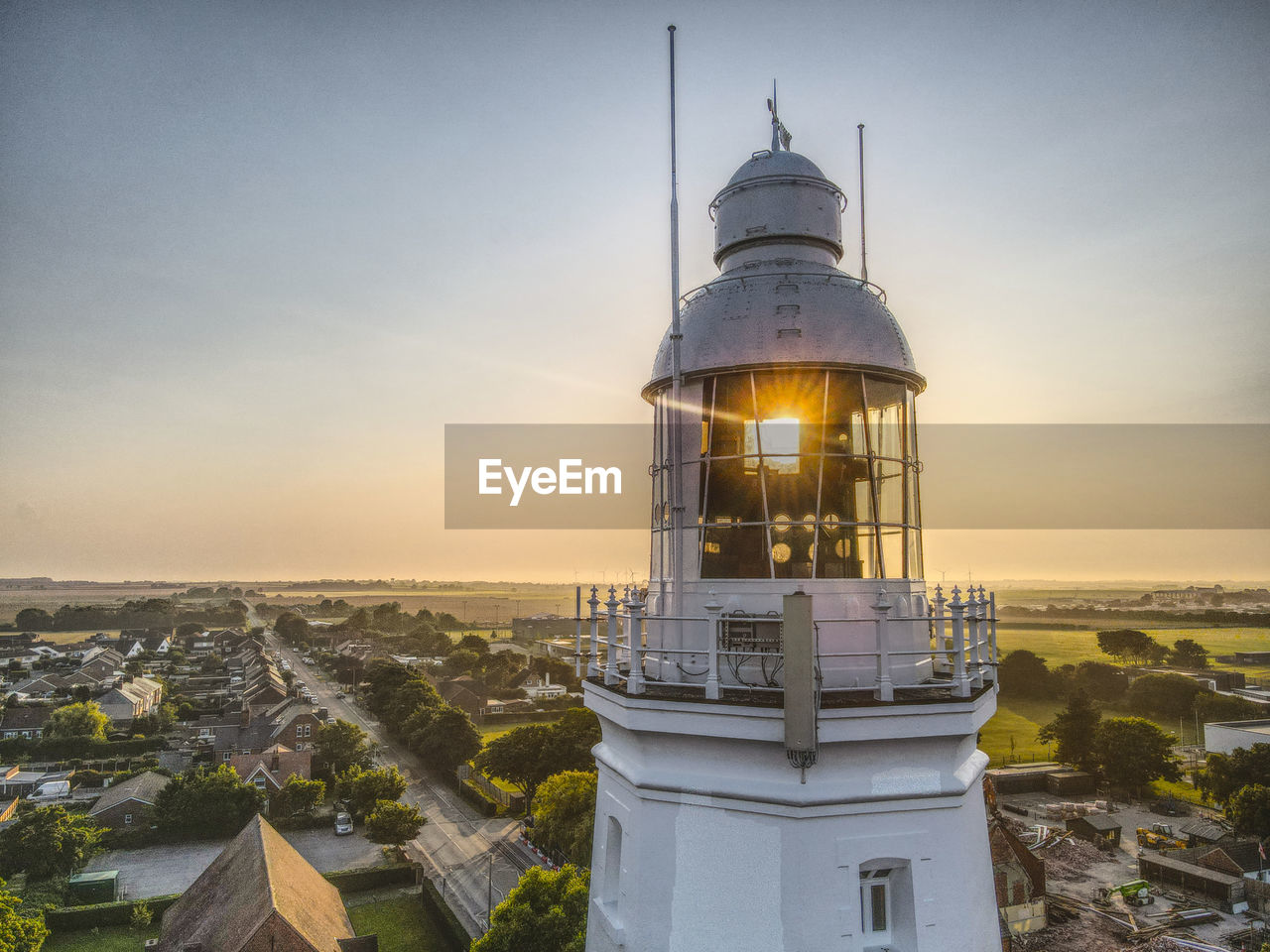 A drone view through the top of withernsea lighthouse at sunset