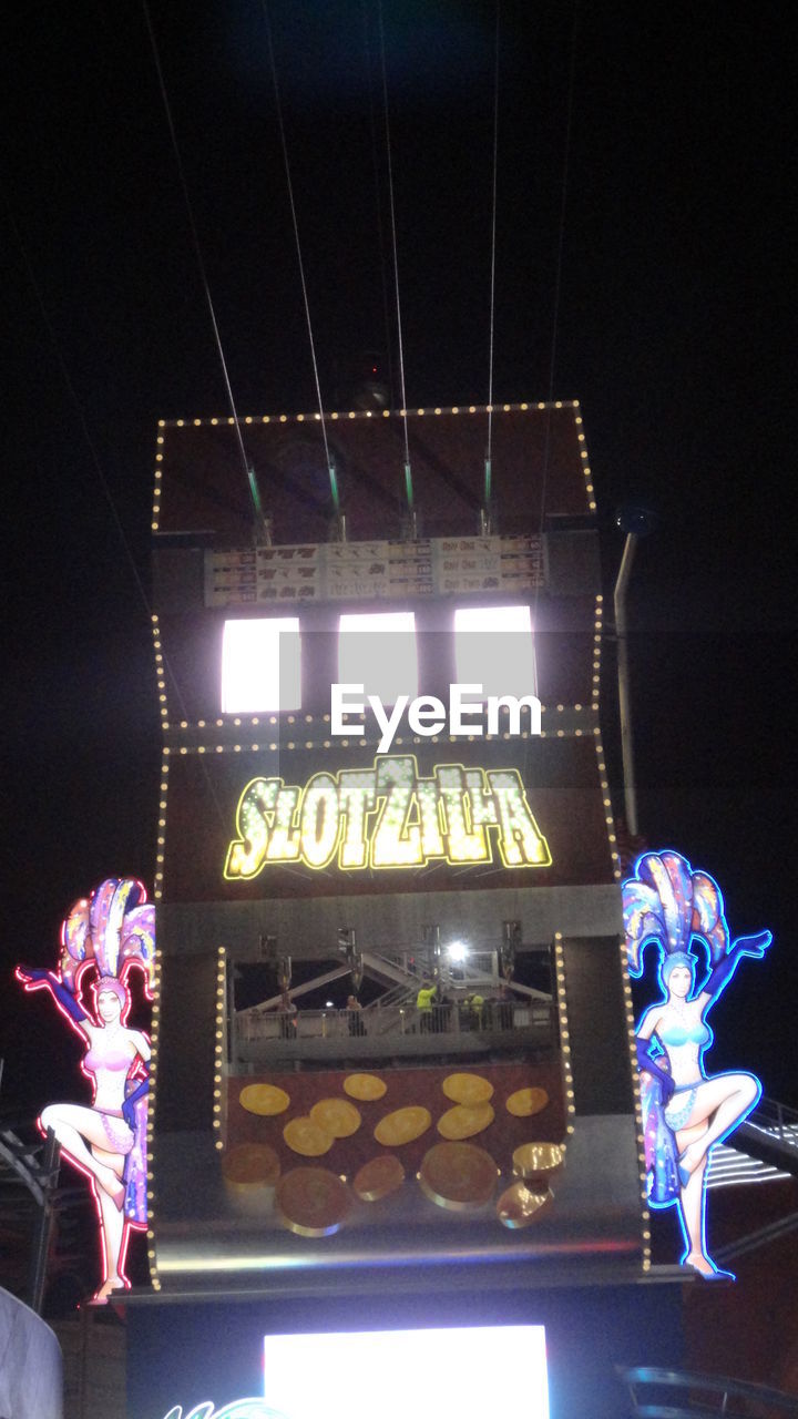 LOW ANGLE VIEW OF ILLUMINATED STAGE AT NIGHT