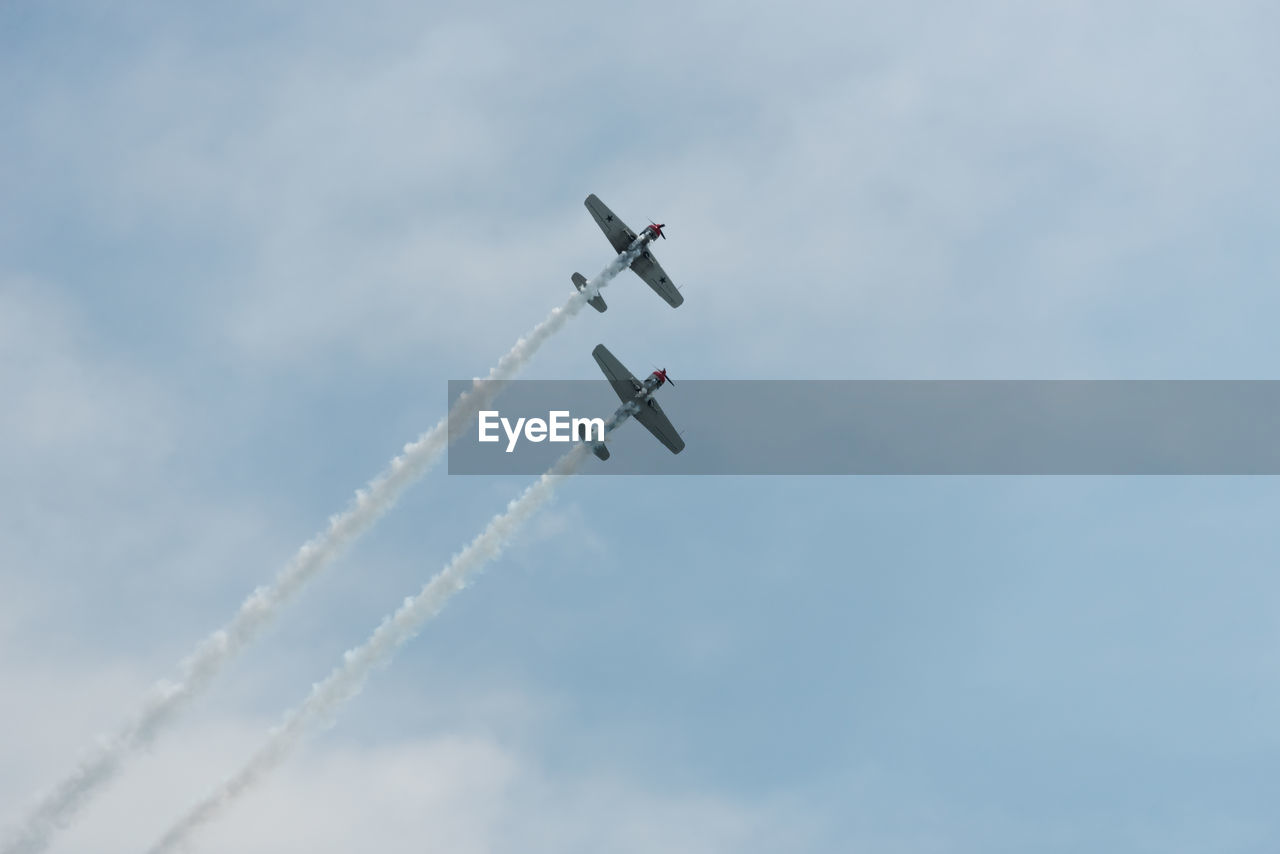 Low angle view of airshow against sky