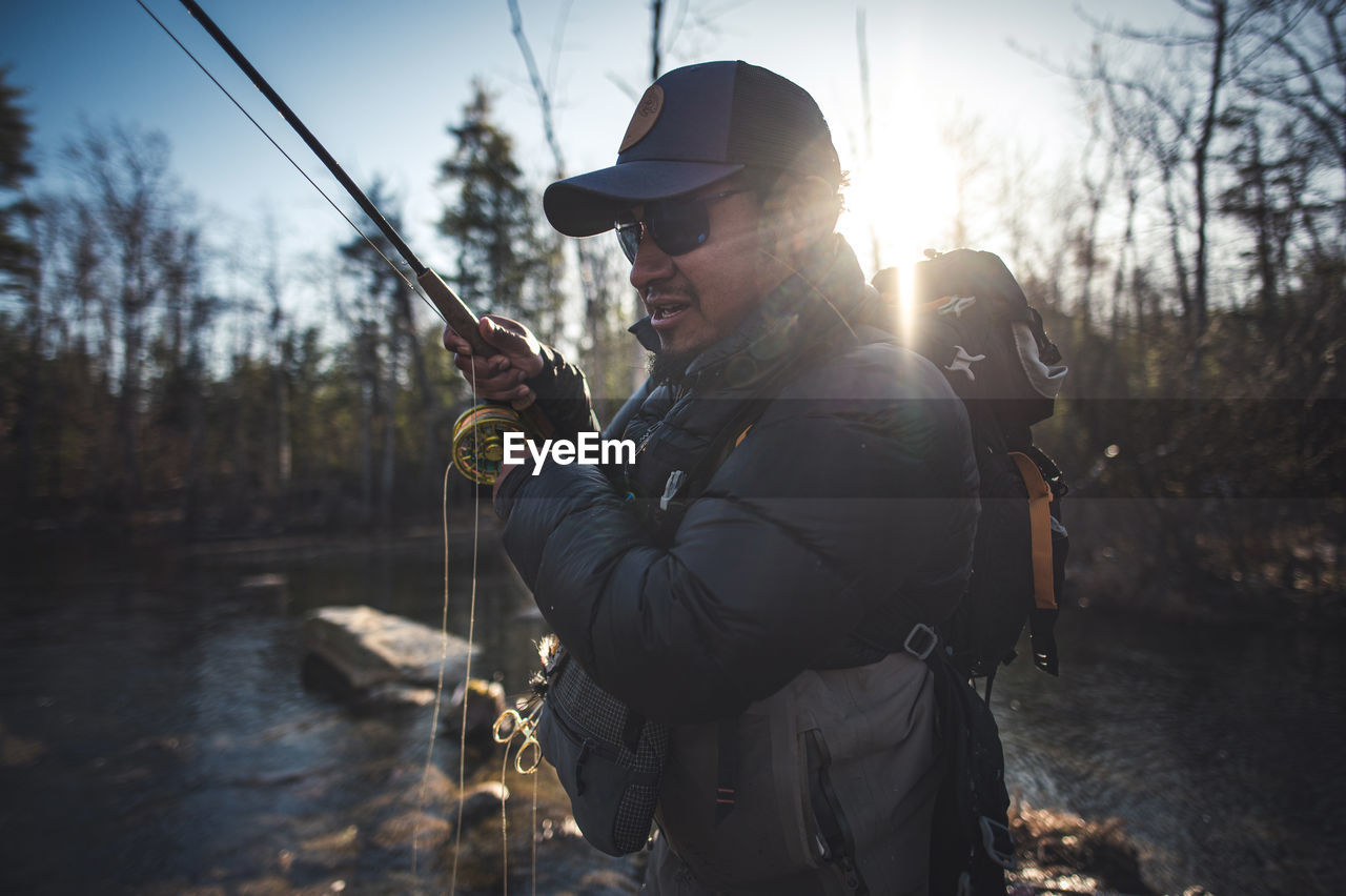 A man fishing in the morning in maine