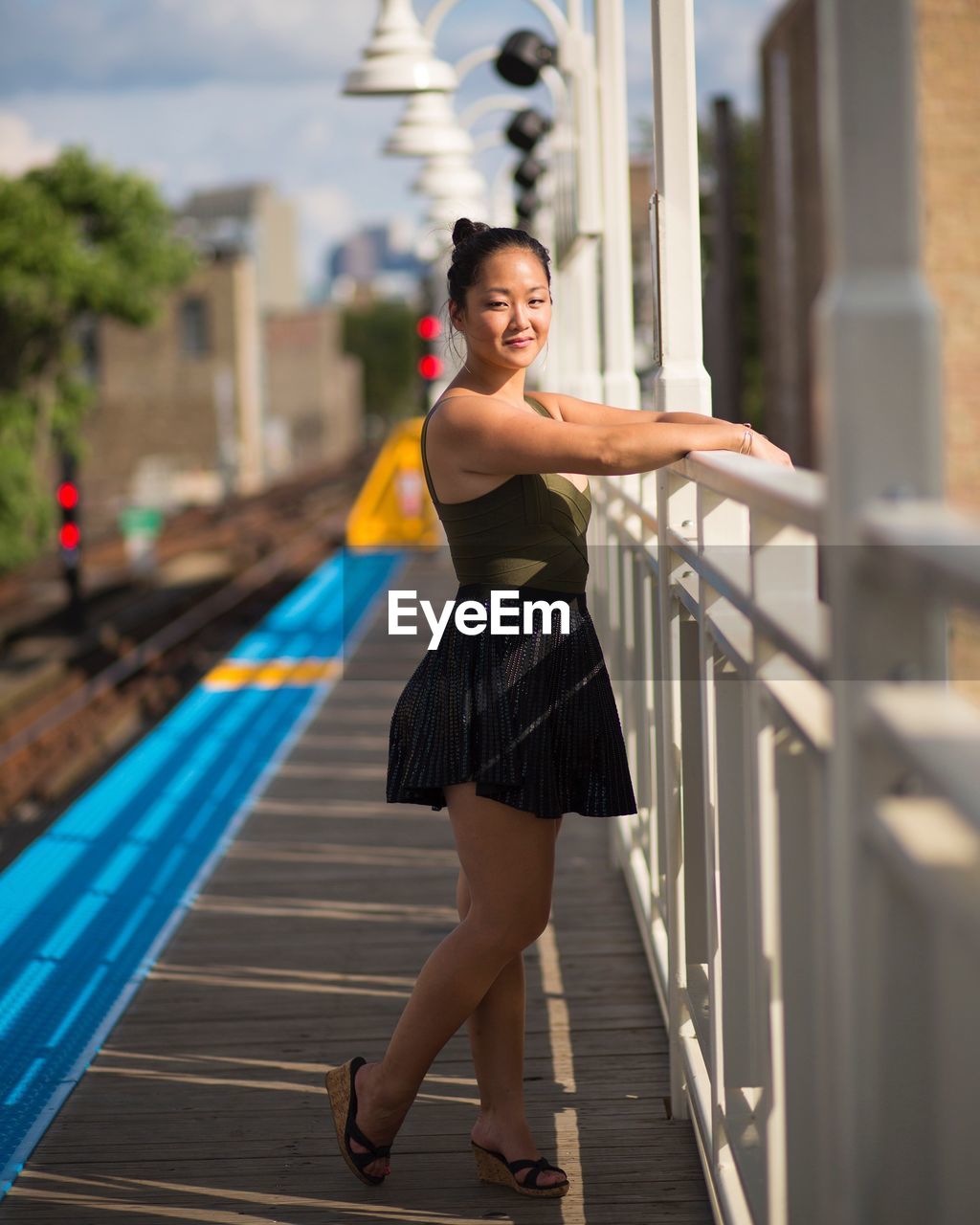 Young woman standing on station platform