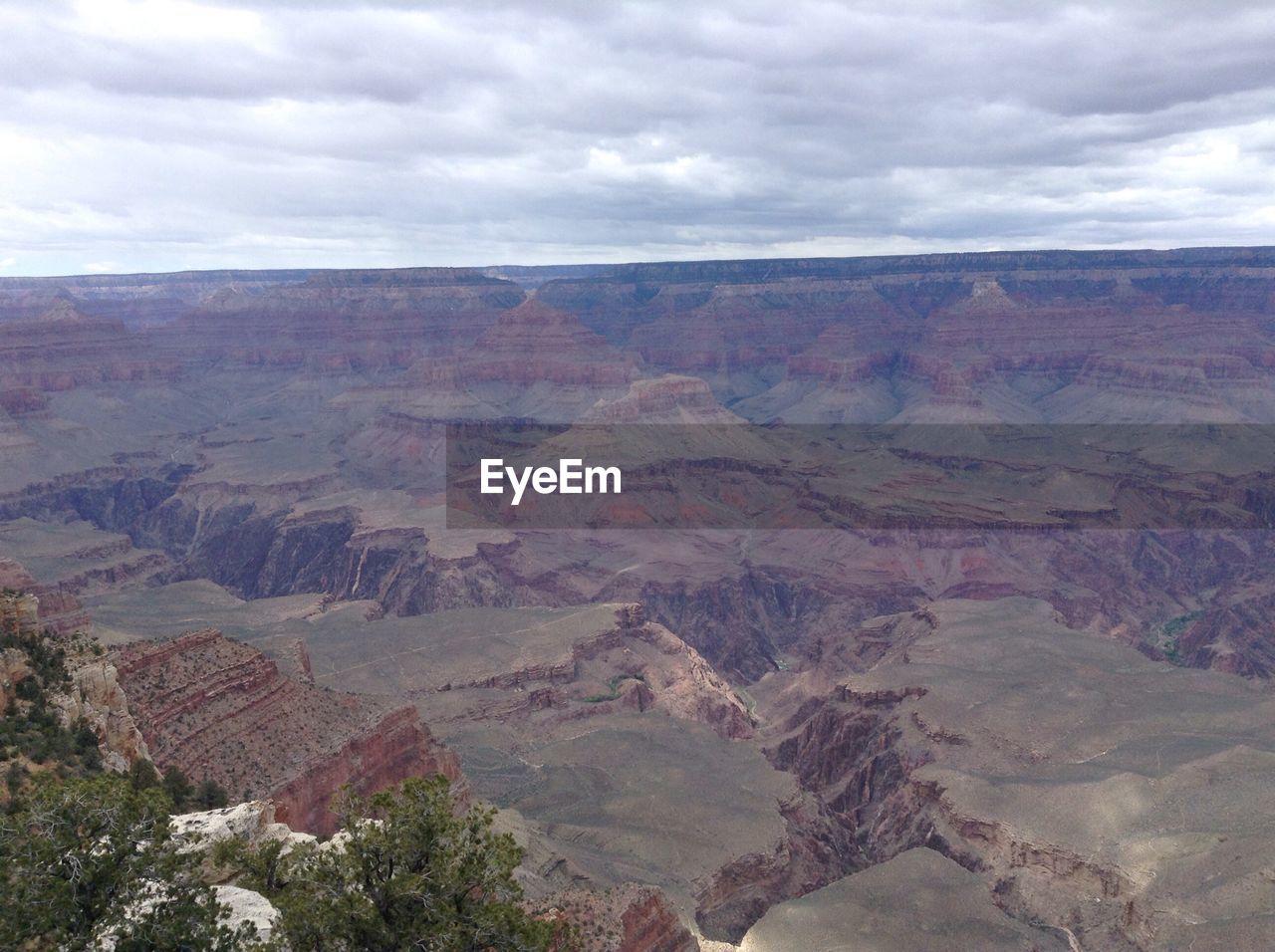 Scenic view of mountains against cloudy sky