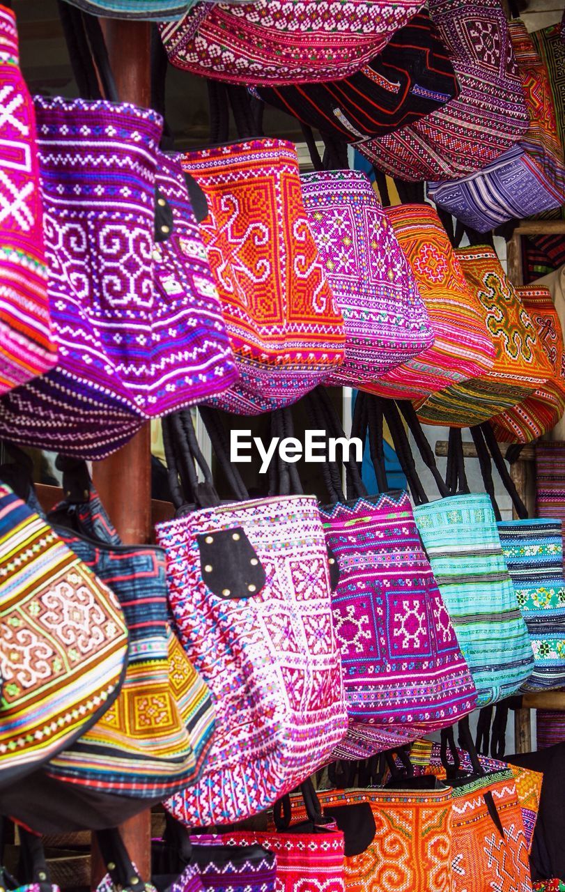 Close-up of colorful bags for sale at market