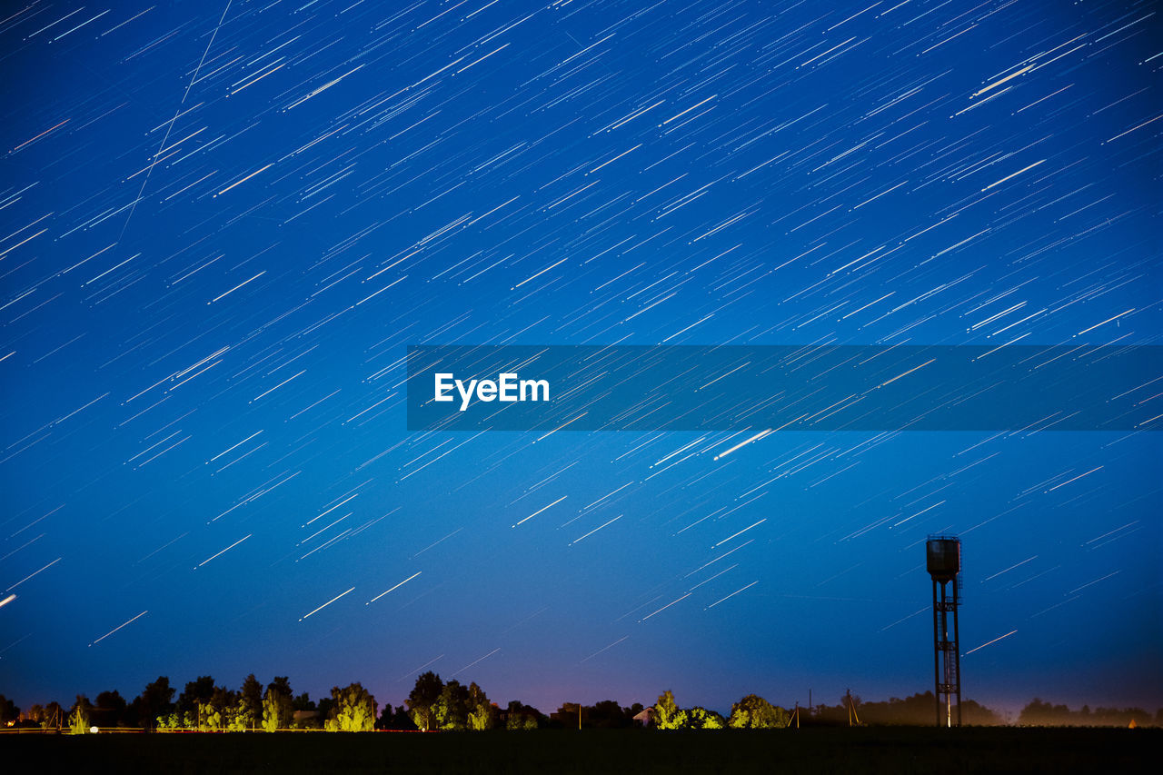 low angle view of trees against sky at night