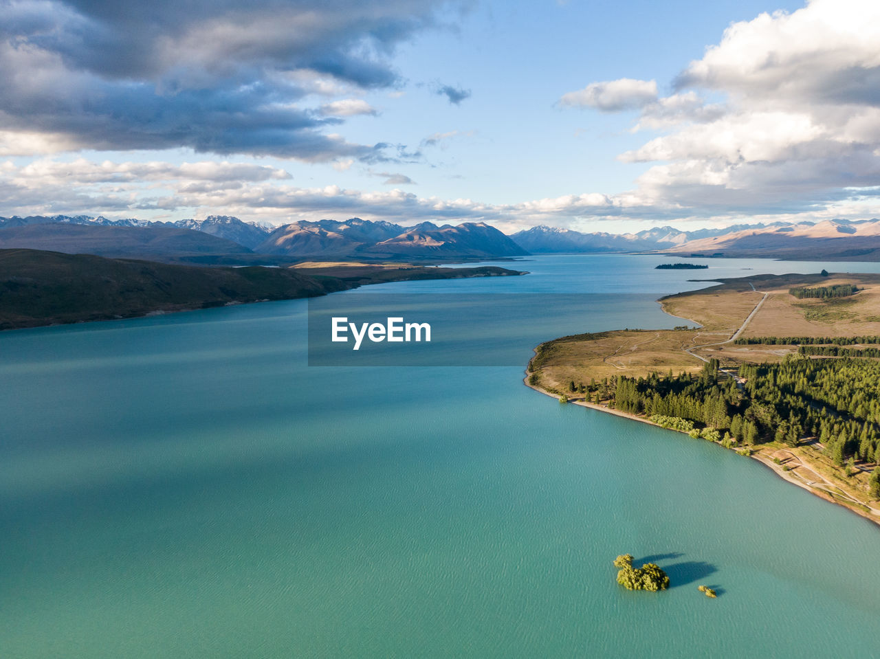 Drone view of lake tekapo on new zealand's south island. southern alps in the background.