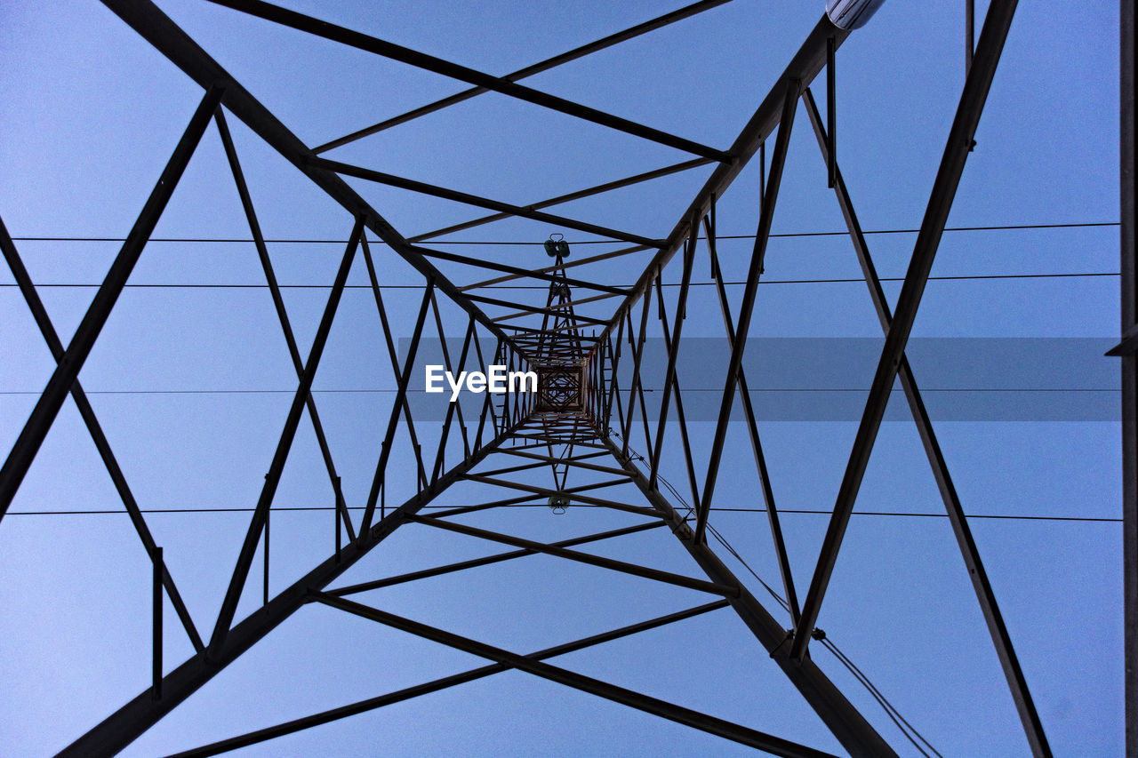 power generation, electricity, electricity pylon, technology, built structure, sky, power supply, architecture, cable, line, no people, pattern, clear sky, tower, grid, nature, girder, communication, metal, arch, low angle view, blue, electrical grid, outdoor structure, silhouette, transmission tower, power line, abstract, directly below, high voltage sign, outdoors, concentric, below, complexity, industry, backgrounds, steel, global communications, hanging, alloy, construction frame