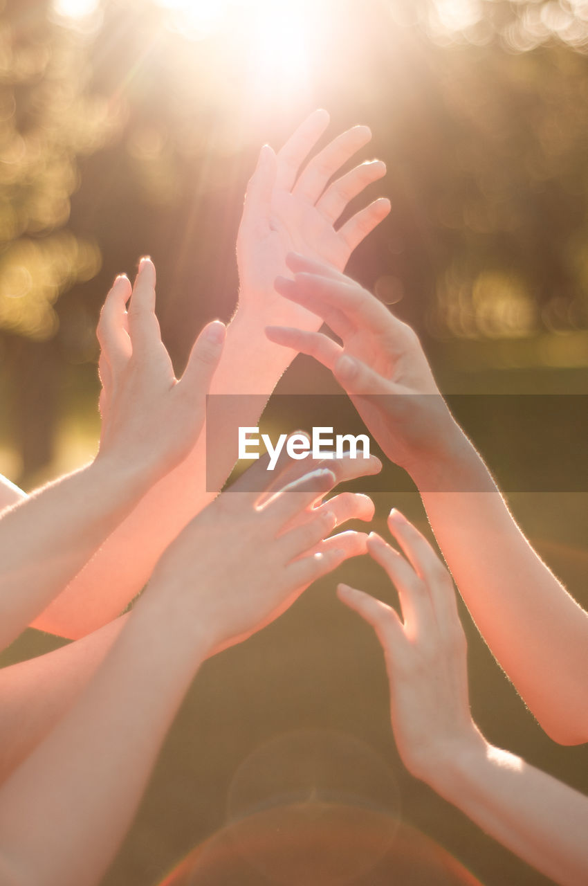 Cropped image of people hands against blurred background