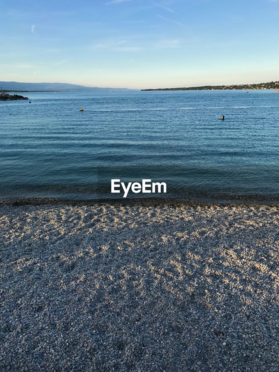 SCENIC VIEW OF BEACH AGAINST BLUE SKY