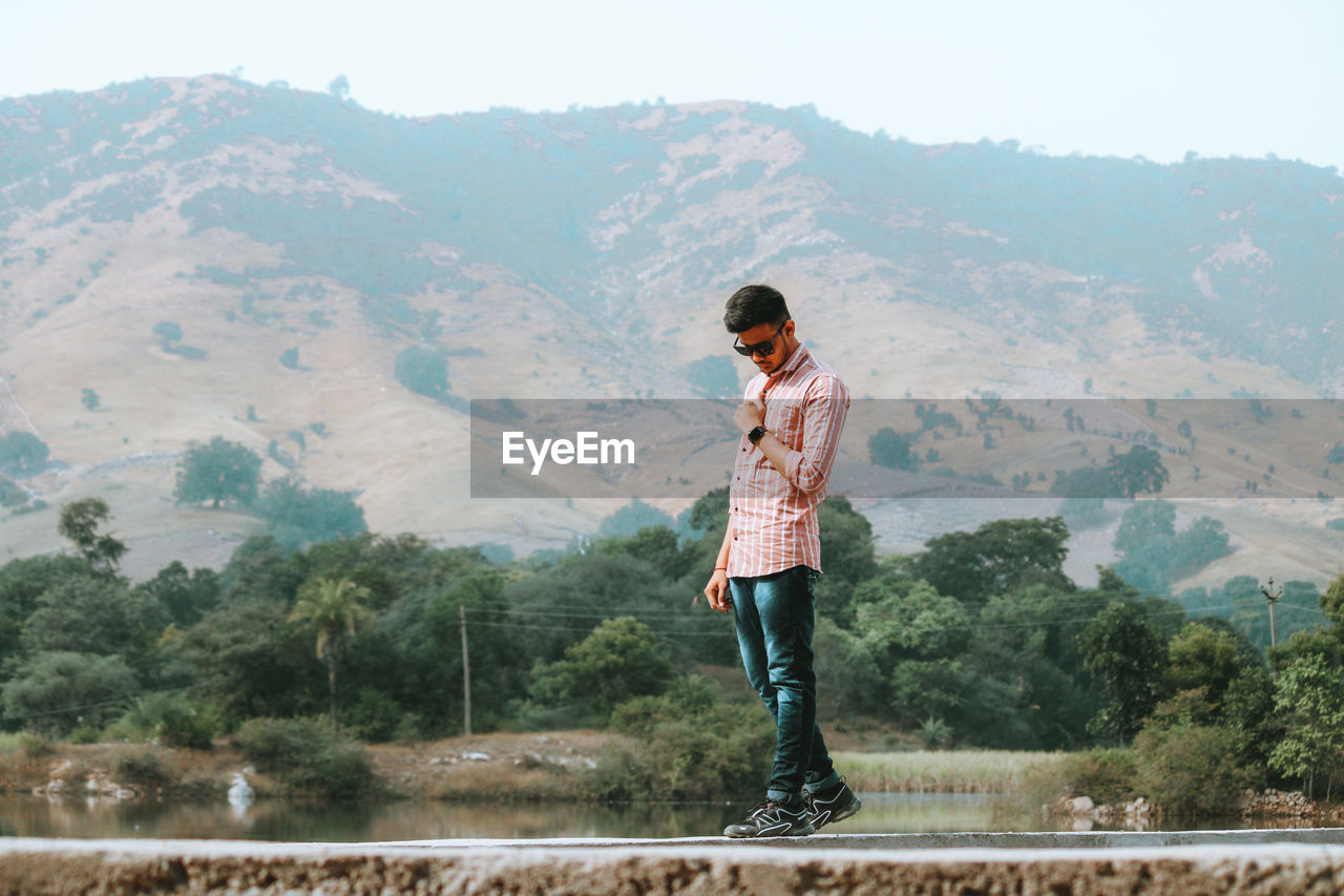 Full length of man standing on mountain