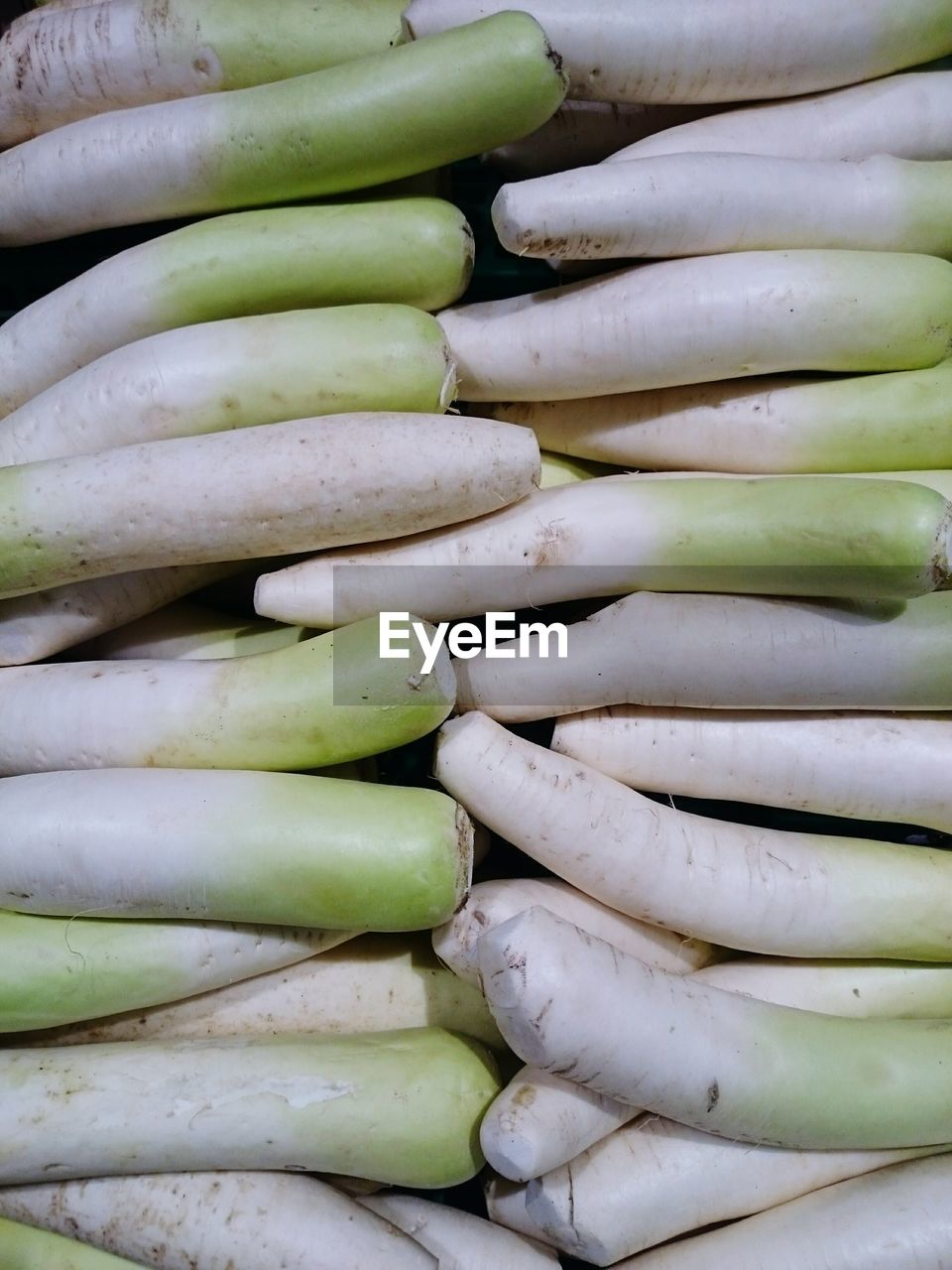 Full frame shot of daikon radish for sale in market