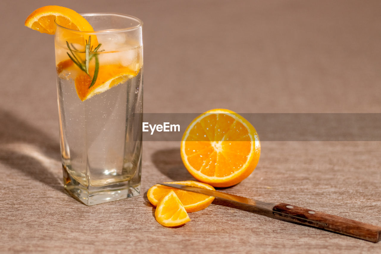 CLOSE-UP OF DRINK AGAINST GLASS