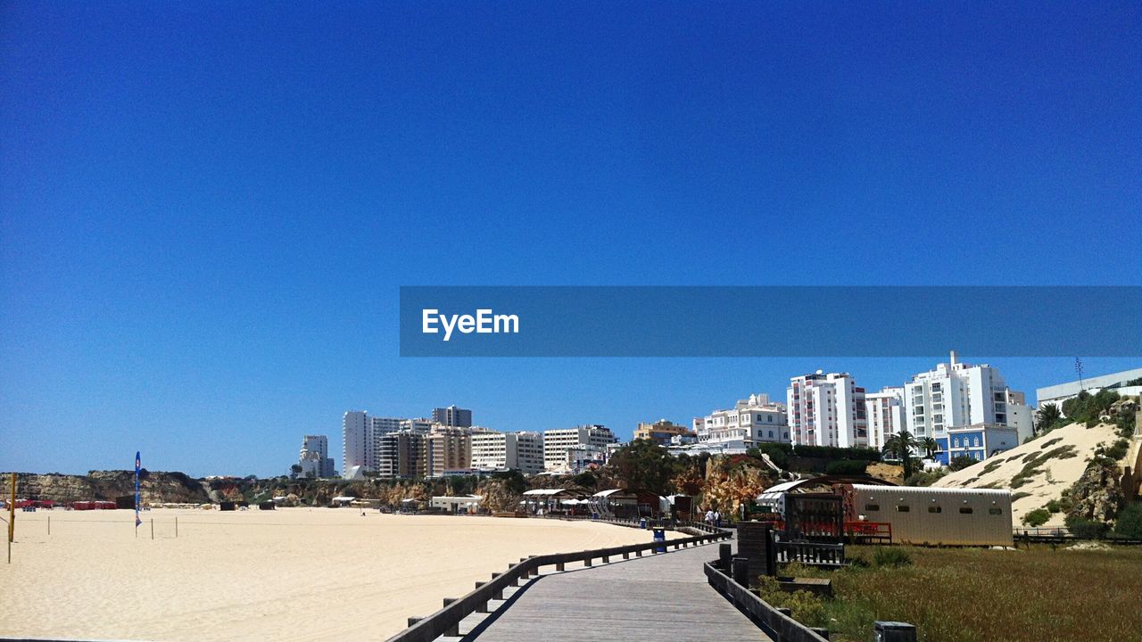 Buildings against clear blue sky