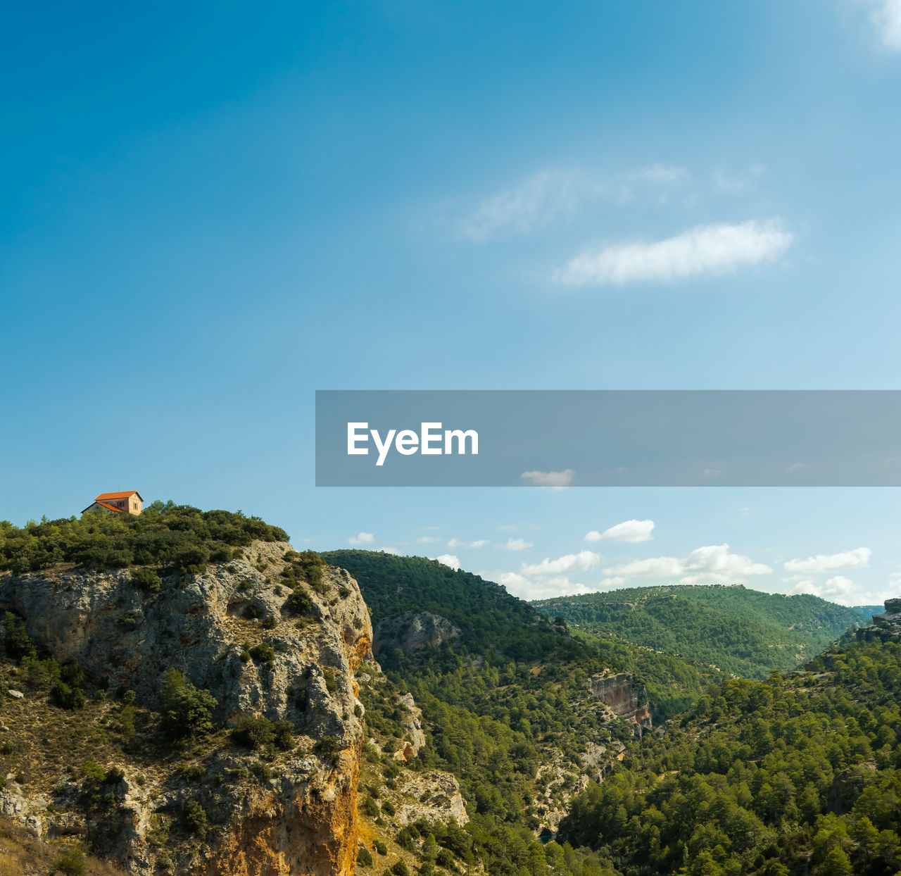 Scenic view of mountains against blue sky