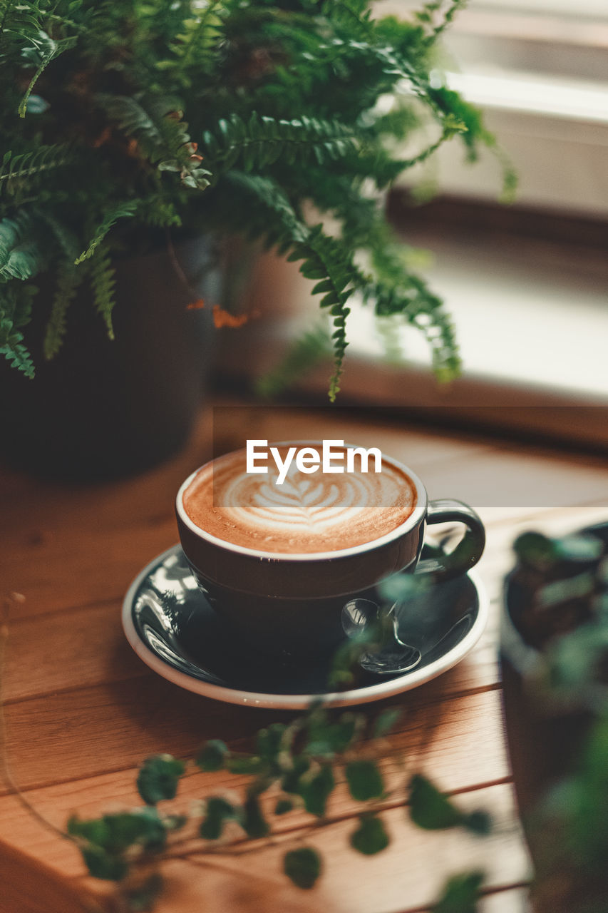 COFFEE CUP ON TABLE AT HOME