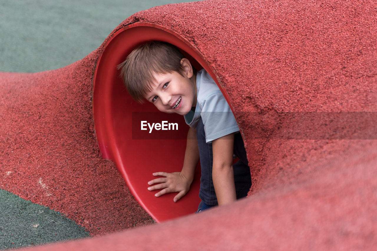 Portrait of smiling boy playing at playground