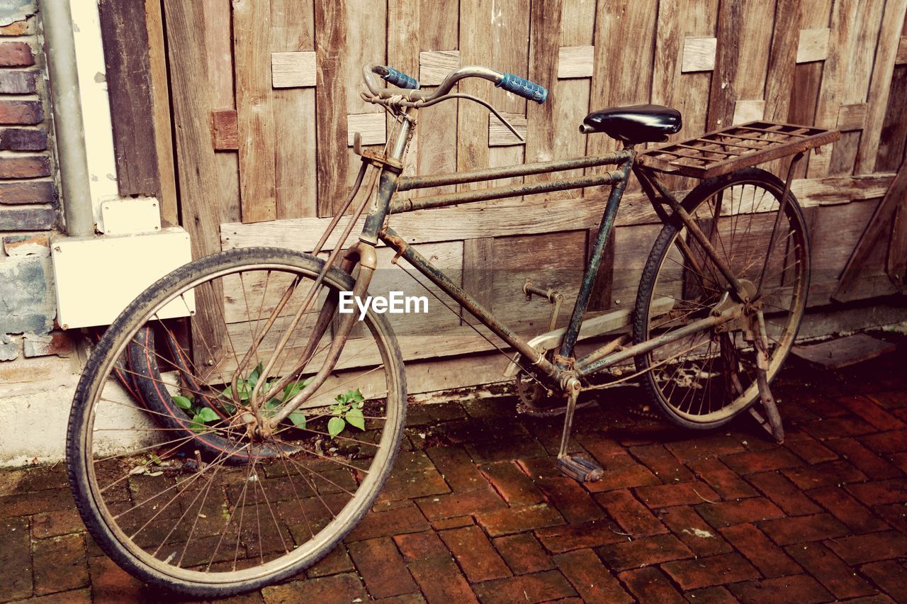 BICYCLE PARKED IN FRONT OF OLD BICYCLES