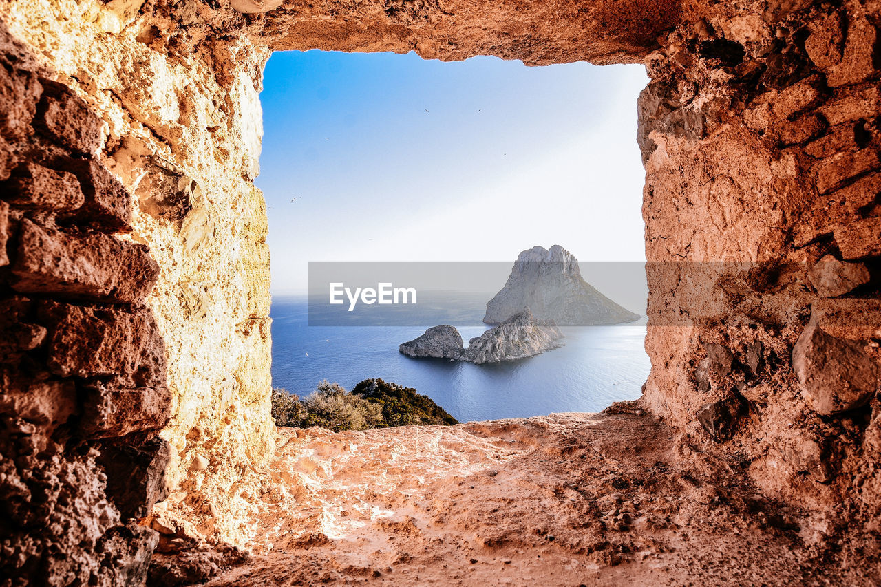 Scenic view of sea against sky seen through rock formation