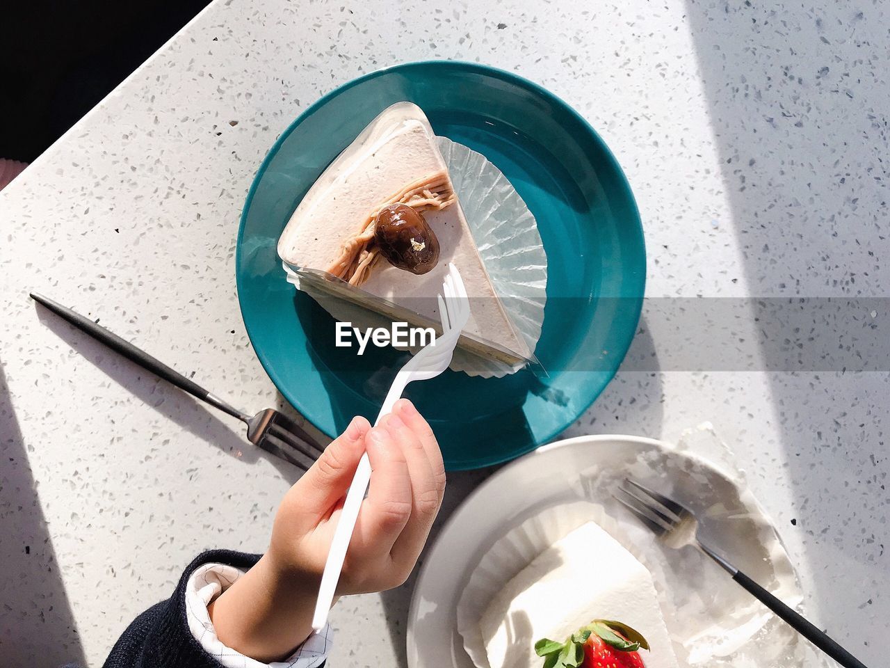 HIGH ANGLE VIEW OF WOMAN HOLDING ICE CREAM IN KITCHEN