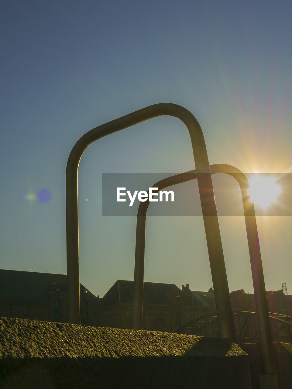 METALLIC STRUCTURE ON FIELD AGAINST SKY DURING SUNSET