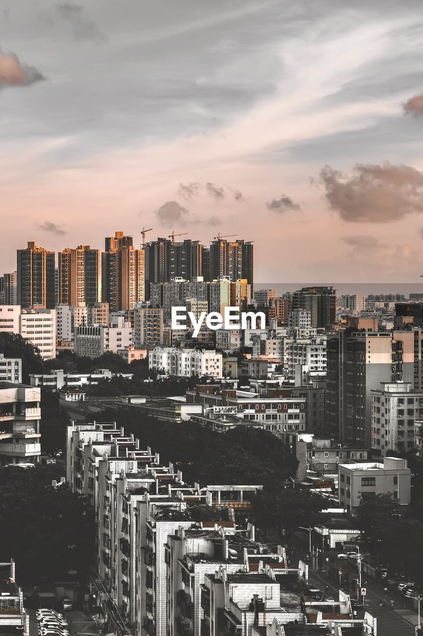 High angle view of buildings in city against sky during sunset