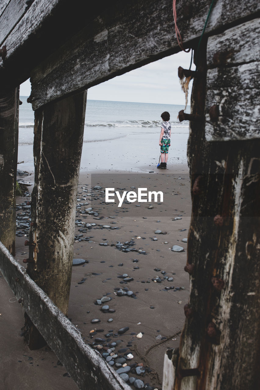 Boy standing on beach