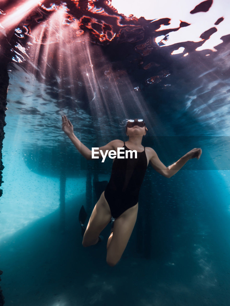 rear view of woman swimming in pool