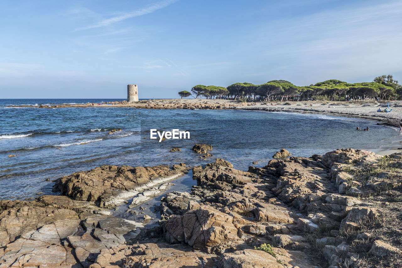 Beach of la caletta in sardinia with an ancient tower