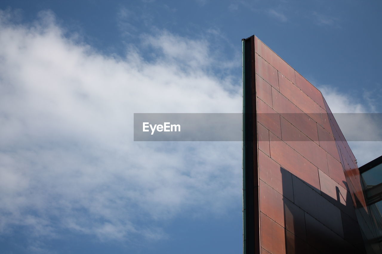 LOW ANGLE VIEW OF MODERN BUILDING AGAINST BLUE SKY