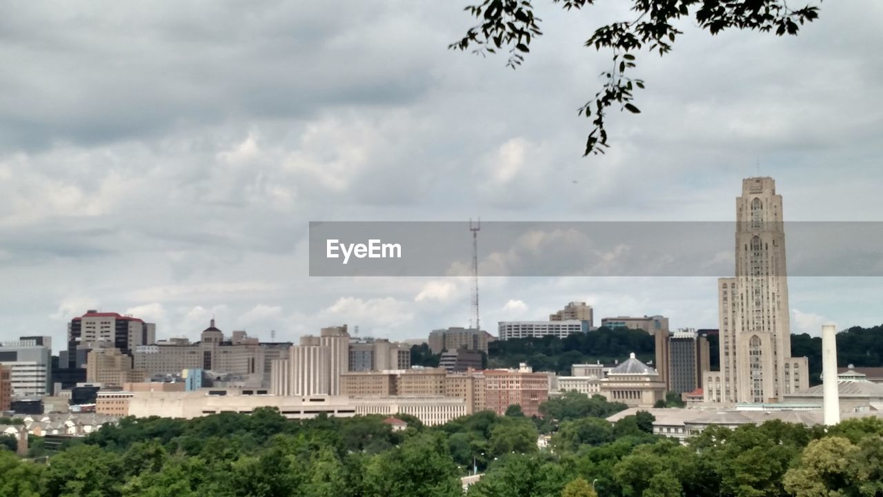 CITY AGAINST CLOUDY SKY