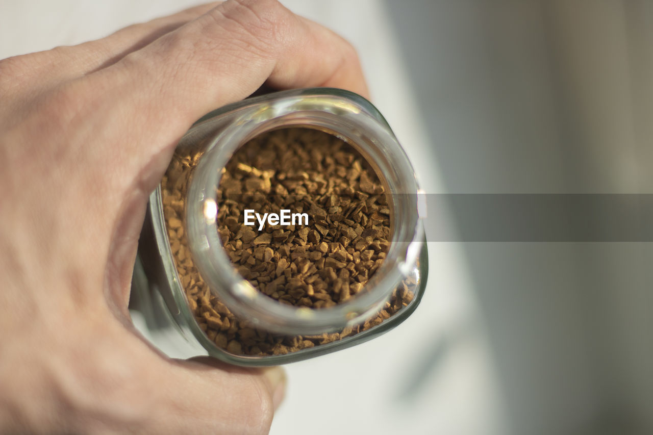 Freeze-dried coffee in a glass jar. coffee drink. granules made from coffee beans.