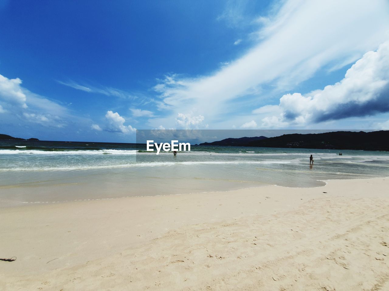 Scenic view of beach against blue sky