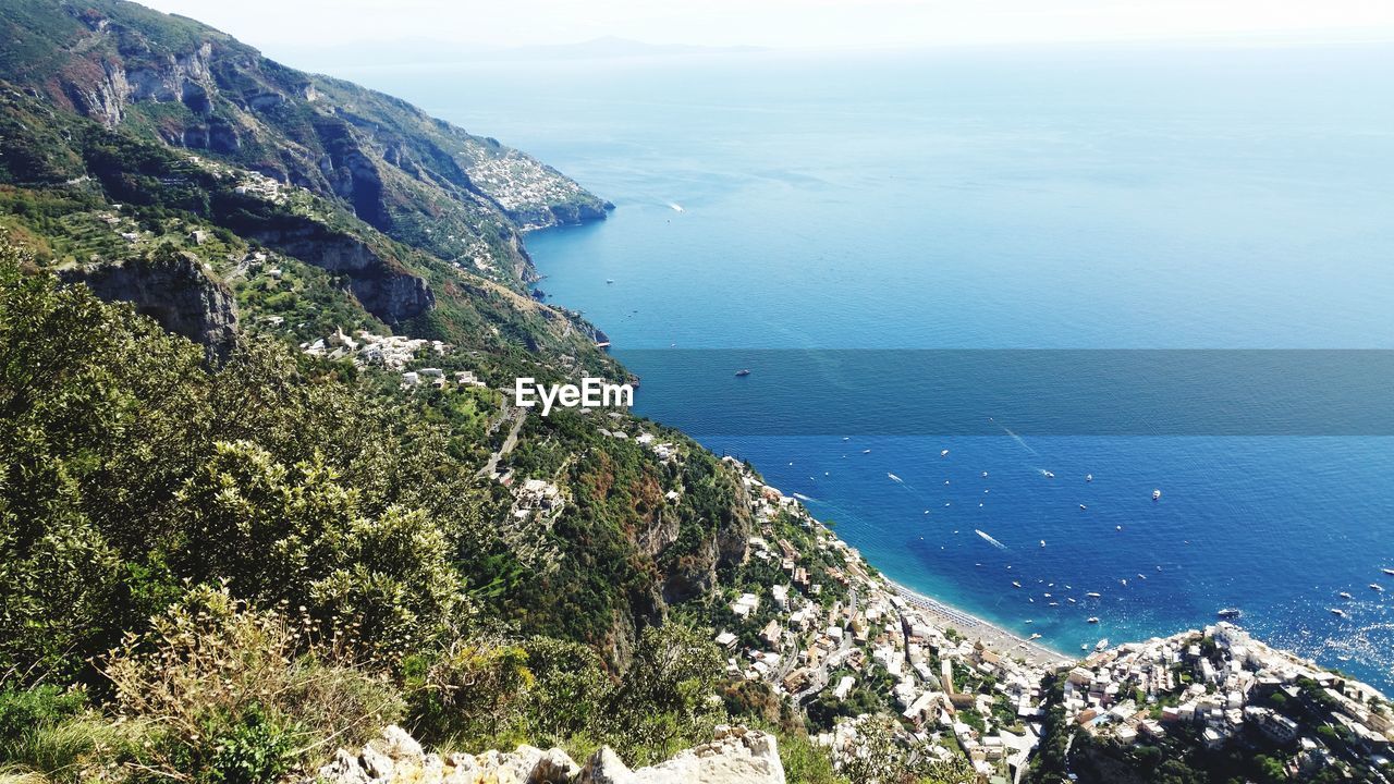 High angle view of sea and mountains against sky