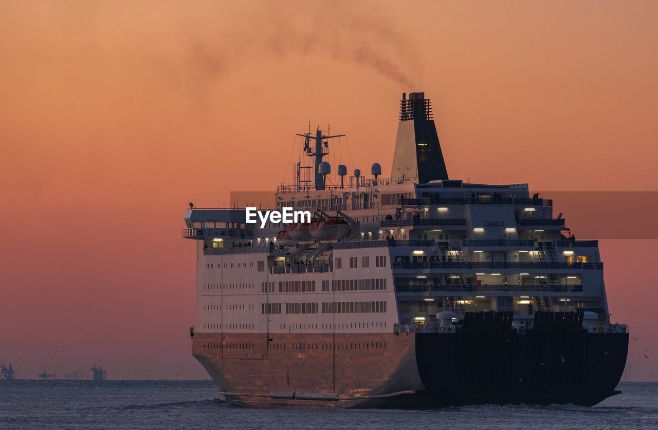 Ferry boat on the ocean during sunset