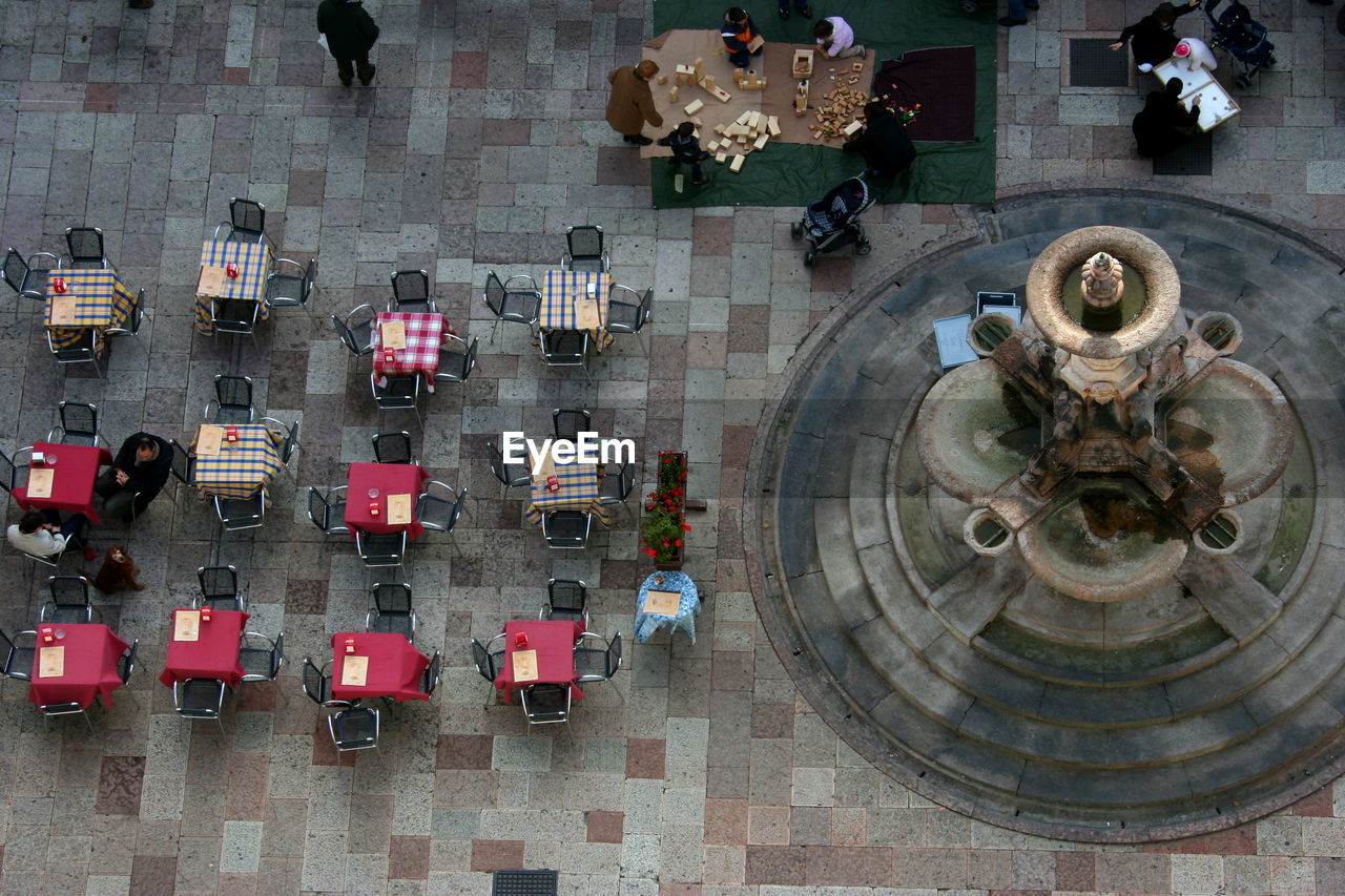 HIGH ANGLE VIEW OF PEOPLE ON STREET AGAINST BUILDING