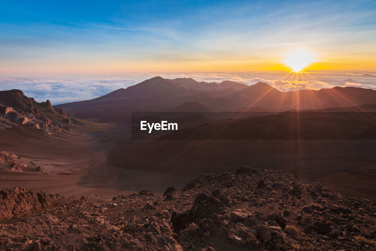 SCENIC VIEW OF MOUNTAINS DURING SUNSET