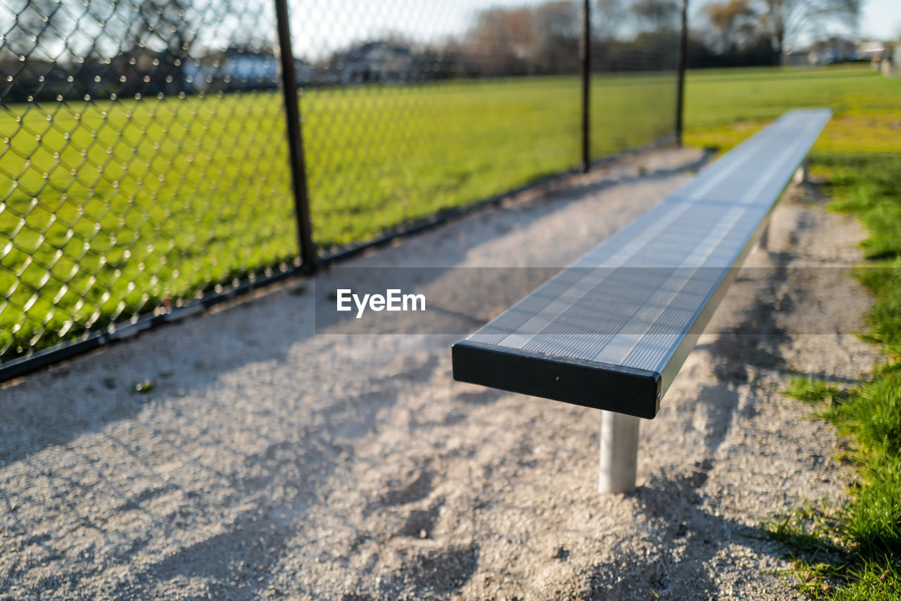 Close-up of empty players bench on baseball field