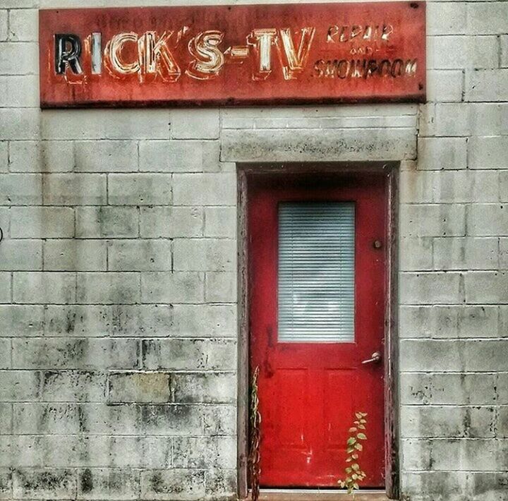 CLOSE-UP OF BRICK WALL WITH CLOSED DOOR