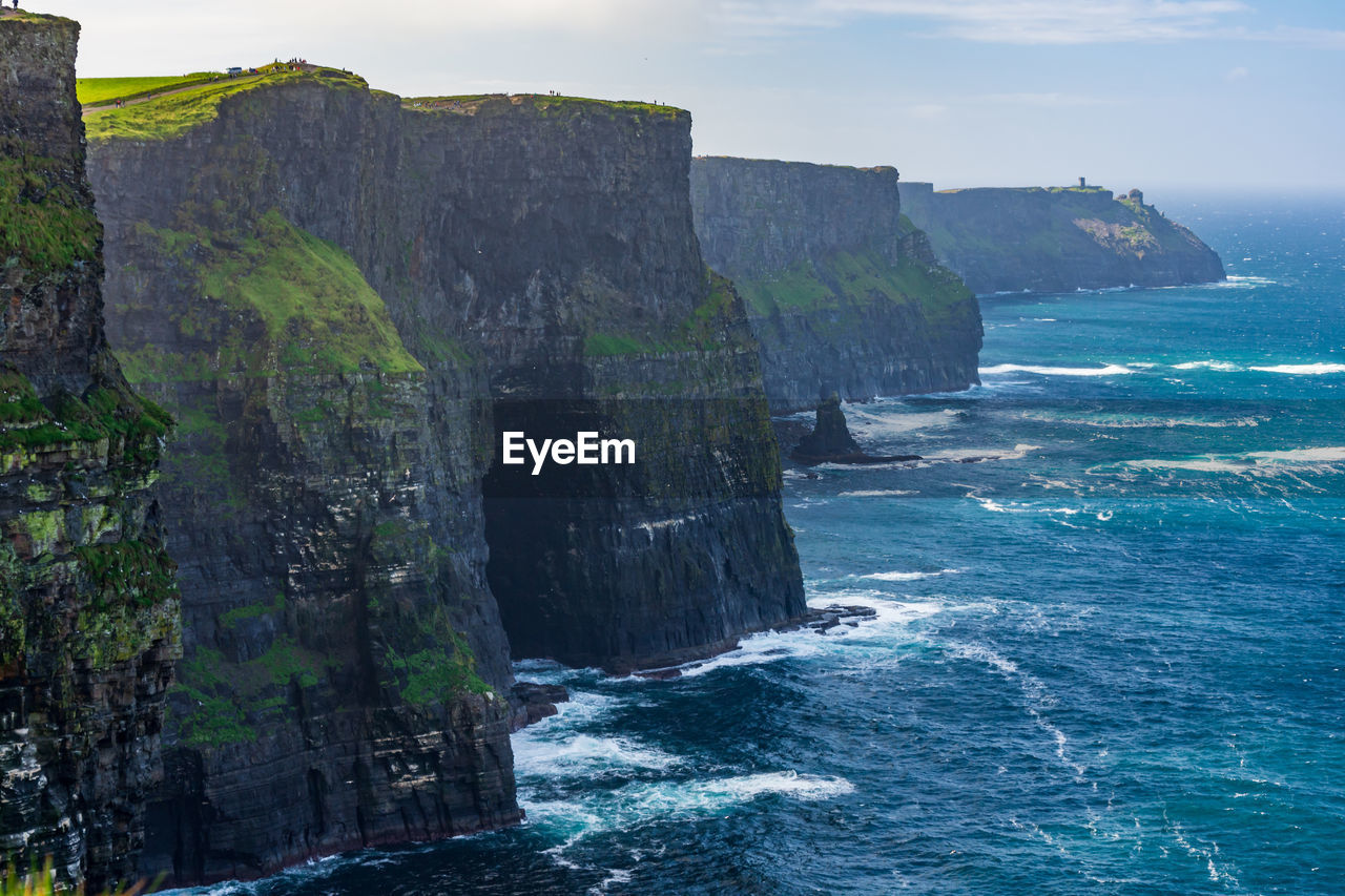 Scenic view of sea against rock formation