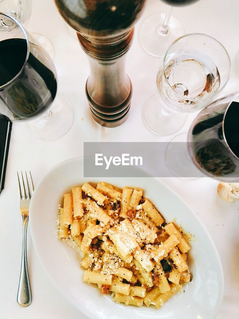 Top view of pasta with wine glass