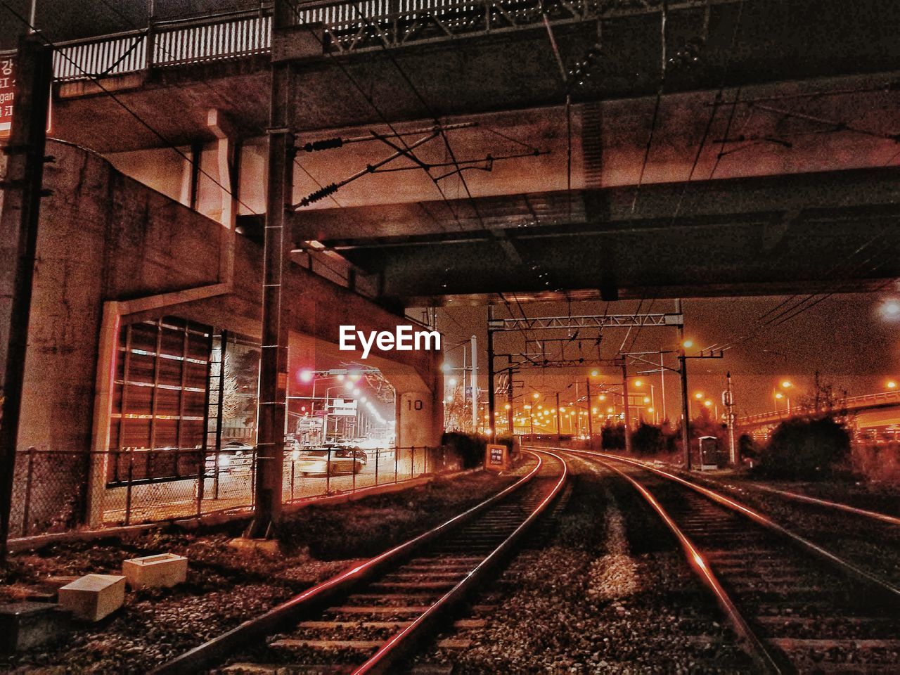 RAILROAD TRACK AGAINST SKY AT NIGHT