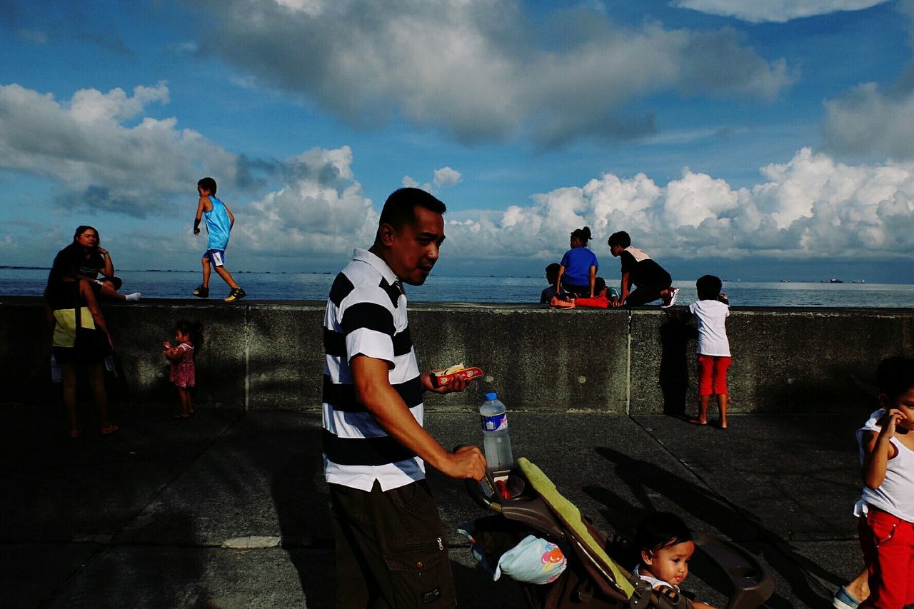 PEOPLE ON BEACH AGAINST SKY