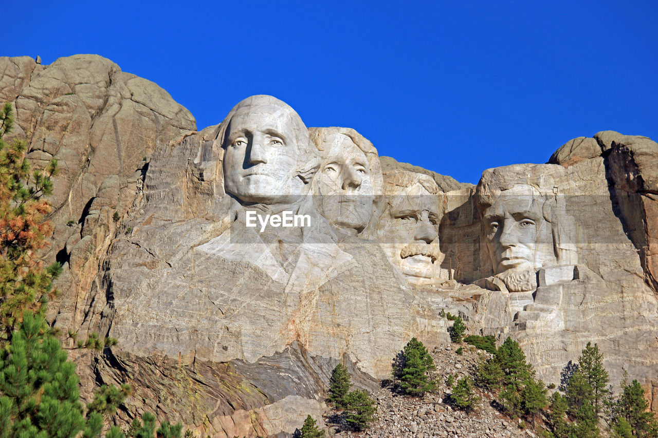 Low angle view of mt rushmore national monument against clear sky