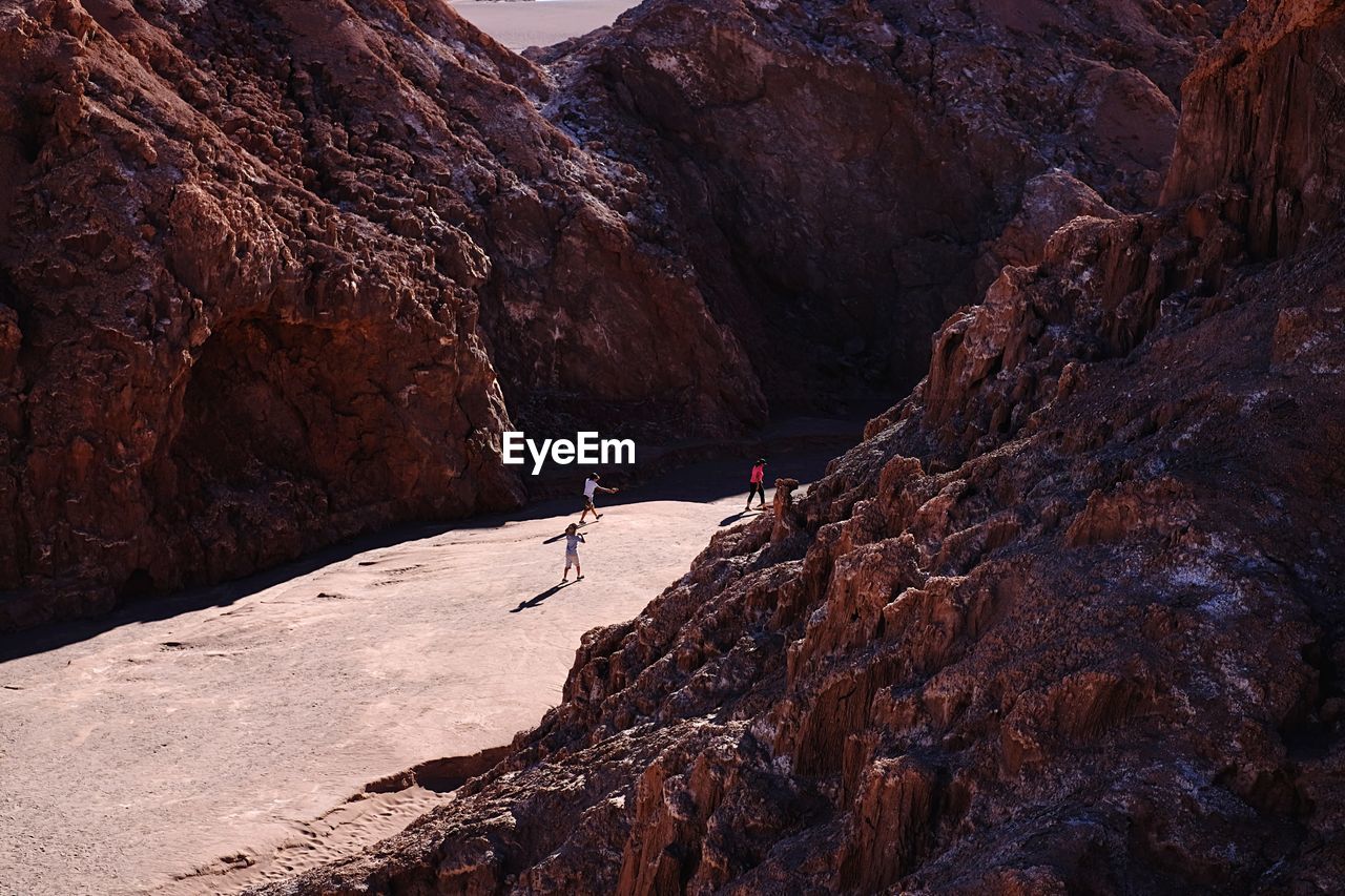 People walking amidst rock formations