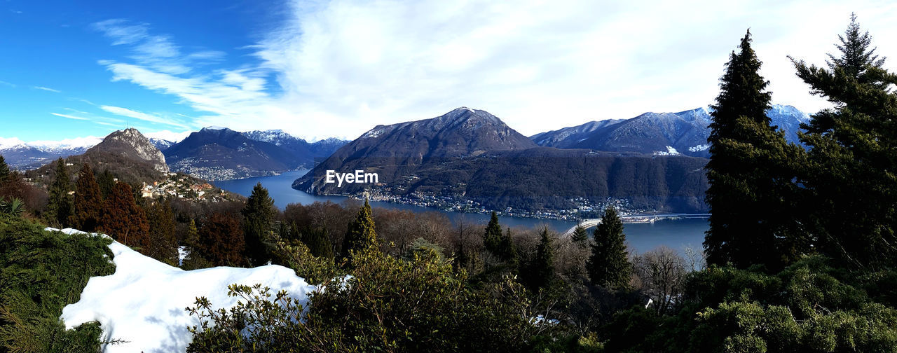 Scenic view of lake and mountains against sky during winter